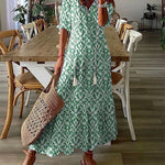 Boho midi jurk met geometrische print, pompon koordjes bij de hals en ruches