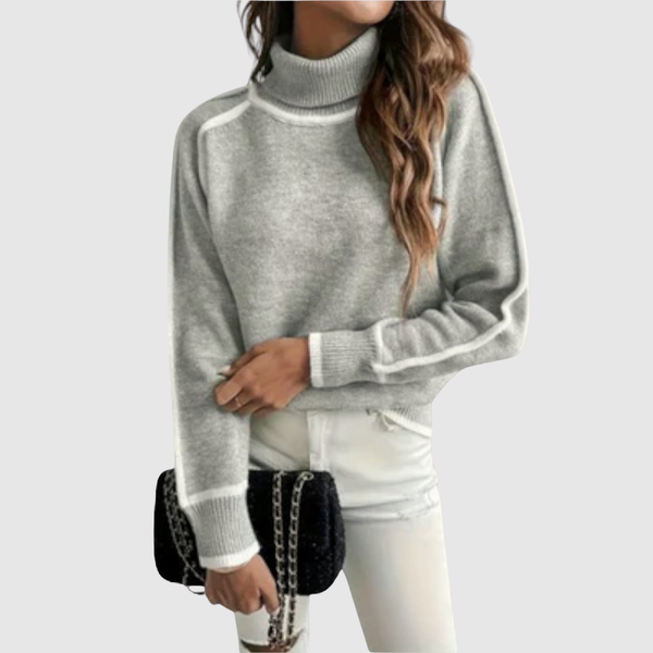 Minimalistische gebreide dames trui met fijne contrastdetails aan hals en boorden