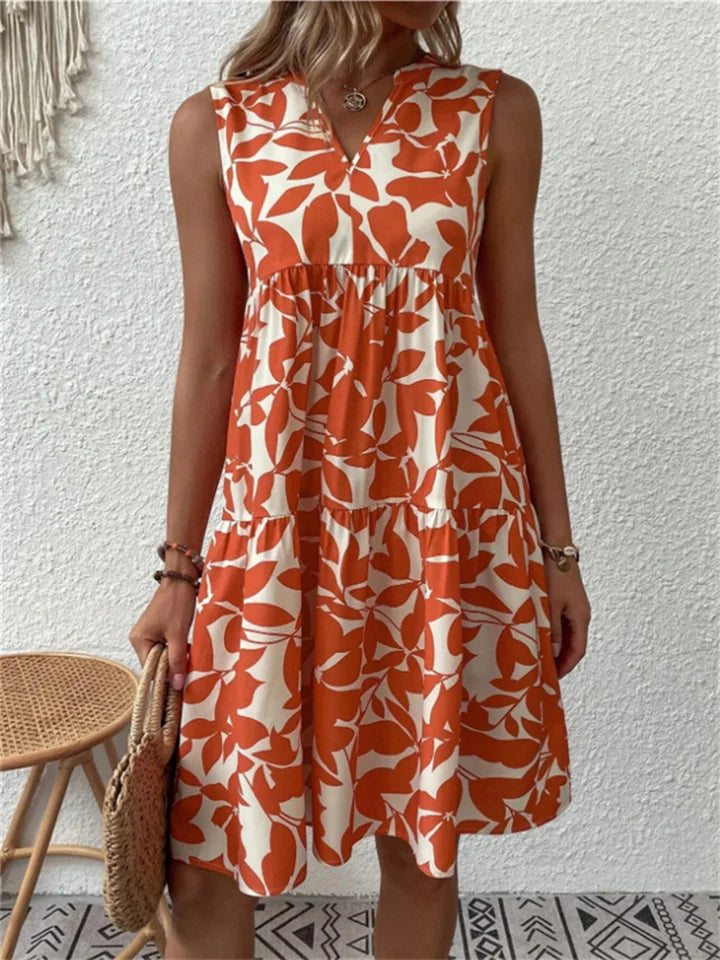 Mouwloze midi jurk met kleurrijke bloemenprint, V-hals en wijd uitlopende rok