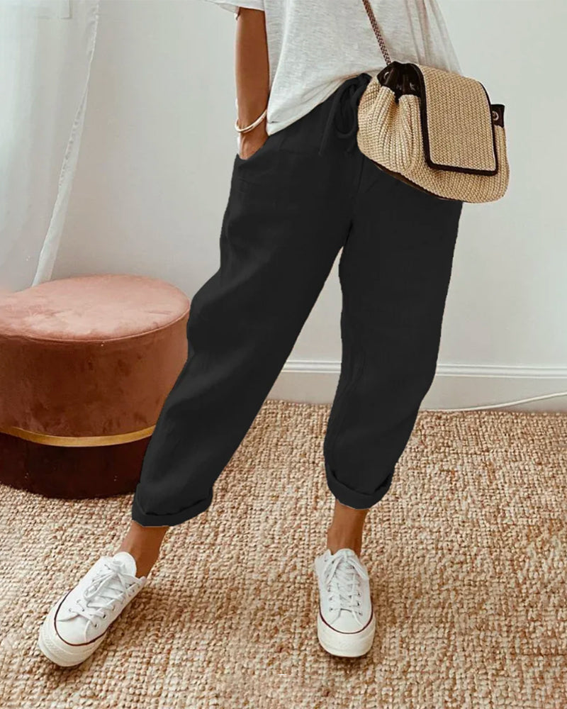Elegante comfortbroek met zachte elastische taille, diepe zakken en soepel vallende pijpen