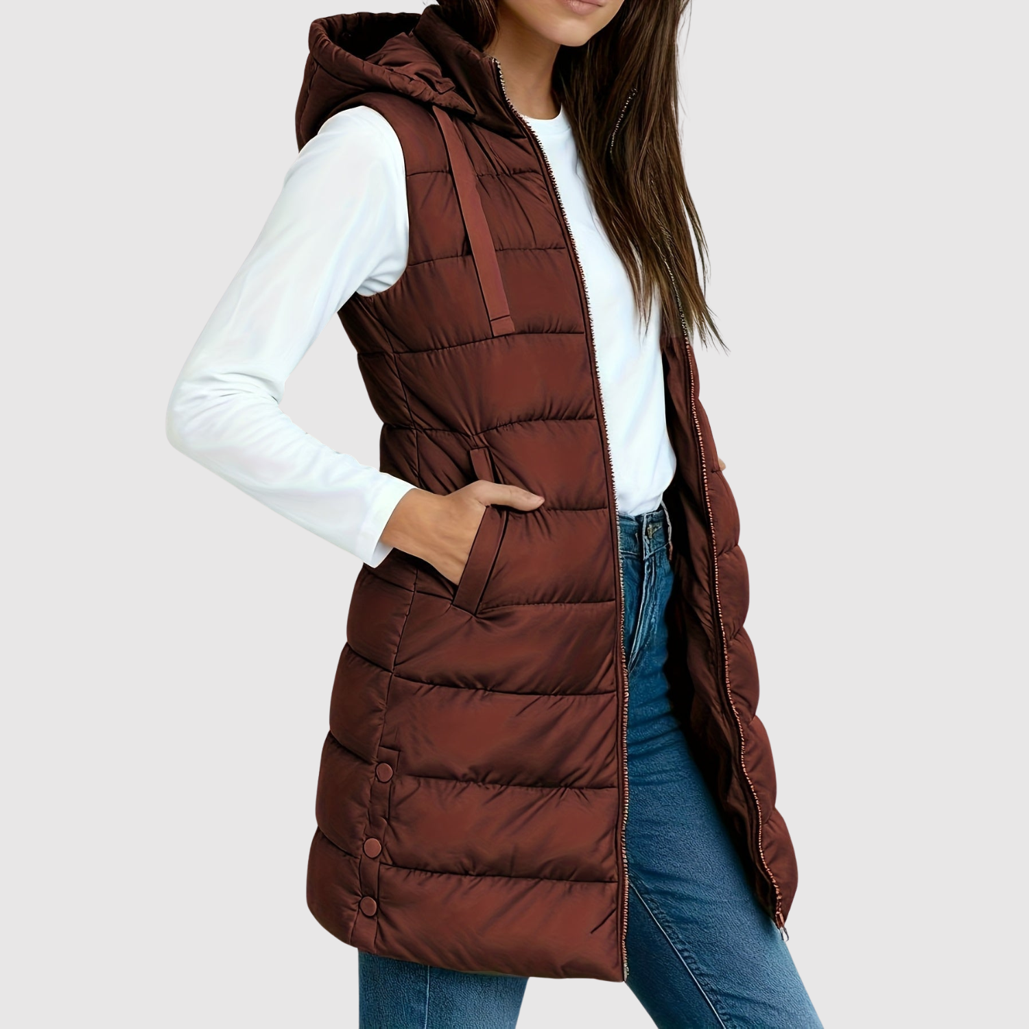 Gewatteerde dames bodywarmer met diepe zakken, gedragen over een trui in het tussenseizoen