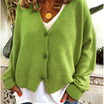 Gebreid vest met v-hals en knoopsluiting voor dames, los gedragen over een effen top