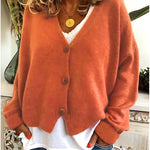 Gebreid vest met v-hals en knoopsluiting voor dames, los gedragen over een effen top