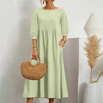 Elegante jurk met ronde hals, 3/4 mouwen, getailleerde taille en vloeiende rok